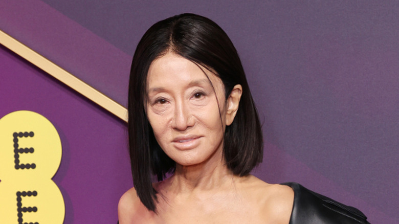 Vera Wang posing in black bralette and coat