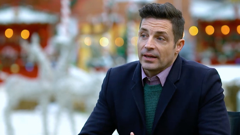 Screenshot from trailer Brennan Elliott in Hallmark movie Christmas at Grand Valley, speaking to someone off screen