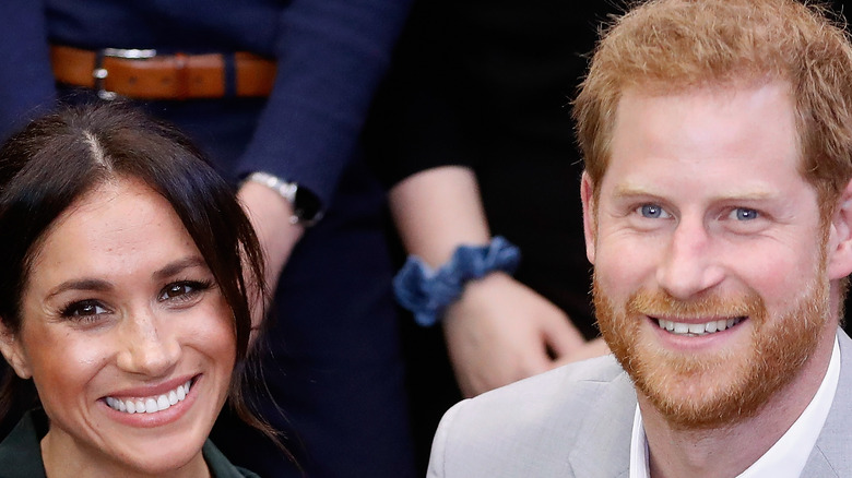 Prince Harry and Meghan Markle pose for a photo. 