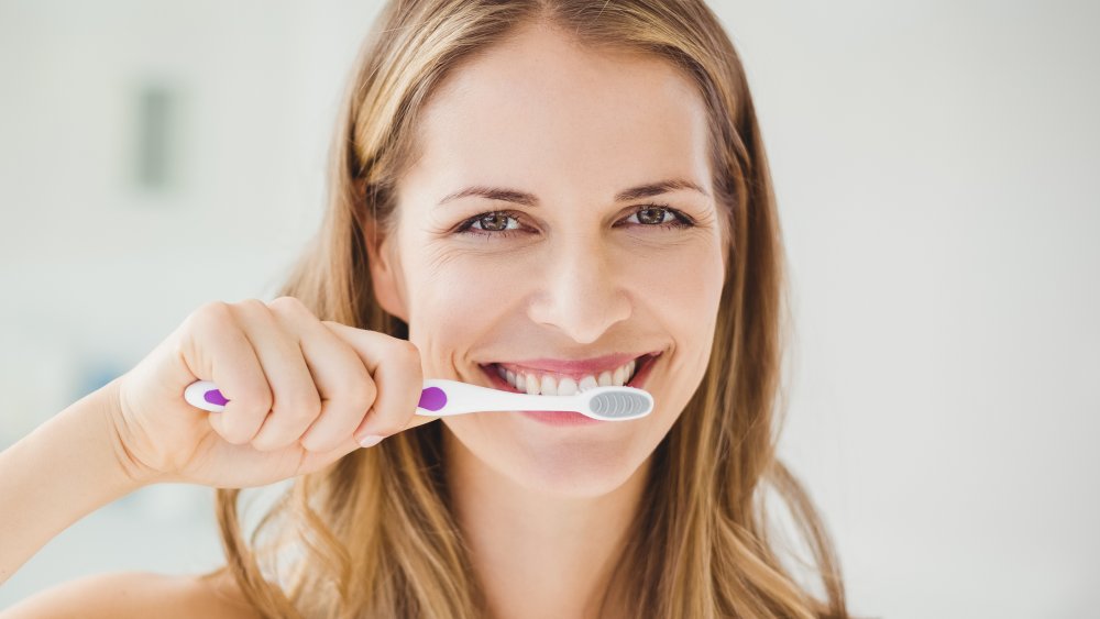 woman brushing teeth