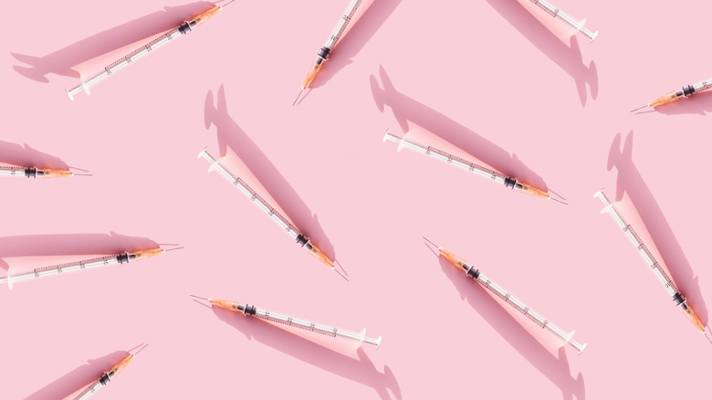 Botox needles on pink background