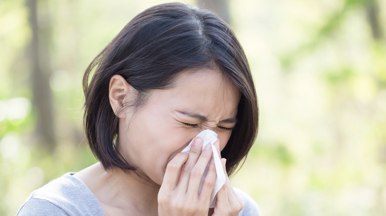 Woman blowing her nose