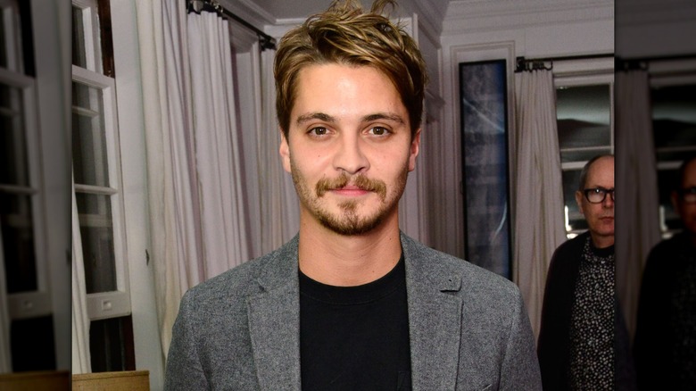 Luke Grimes wearing blazer at Art of Elysium book launch