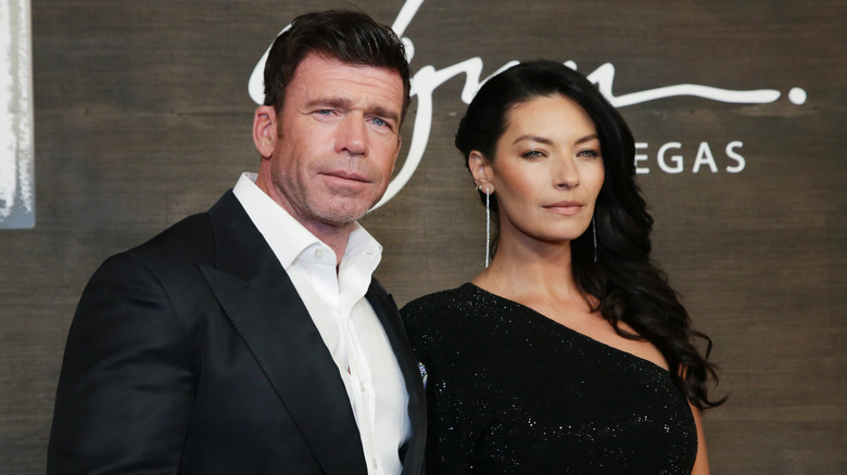 image of Taylor Sheridan and his wife Nicole Muirbrook with enigmatic smiles at an event