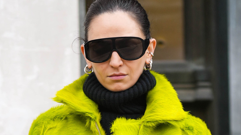 Woman wearing green furry jacket