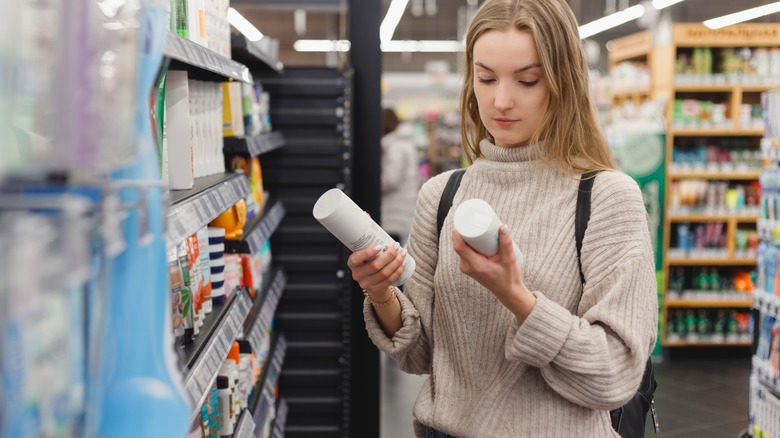 woman looking at skincare products