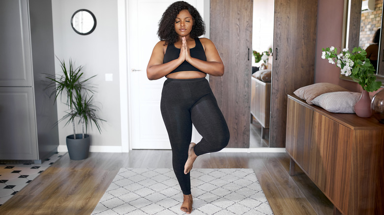 Woman practicing yoga at home