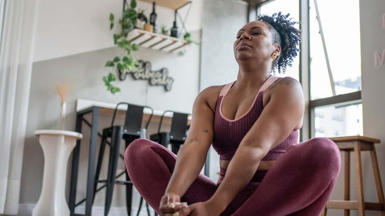 Woman practicing yoga at home