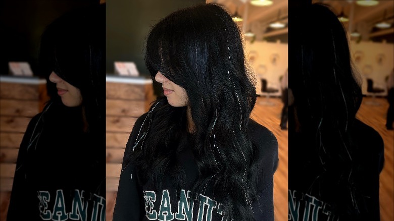 woman with black hair and tinsel
