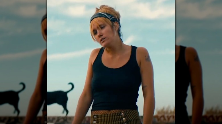Eden Brolin standing outside against blue sky in the movie "Tyger Tyger"