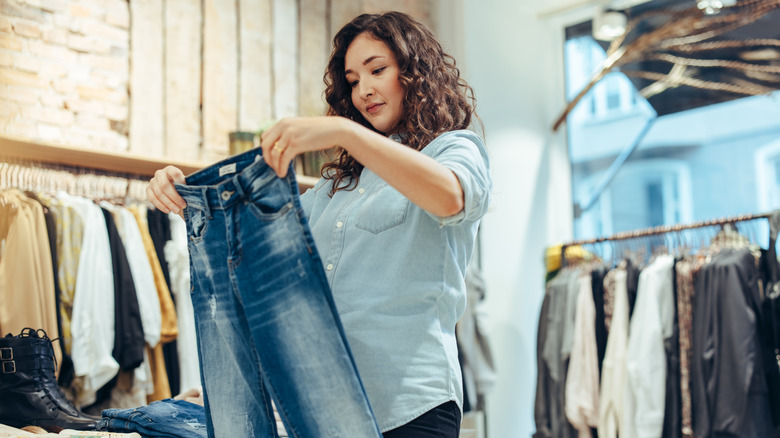 Woman shops for blue jeans 