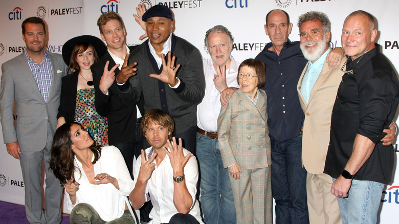 The cast of NCIS: LA poses at an event