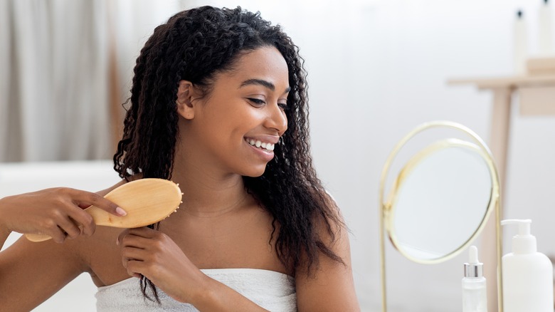 Black woman brushing her hair