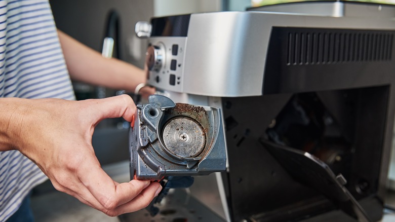 woman cleaning coffeemaker