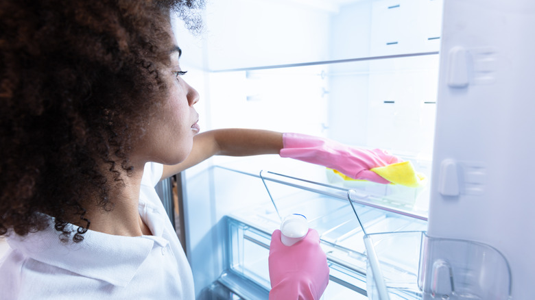 woman cleaning fridge