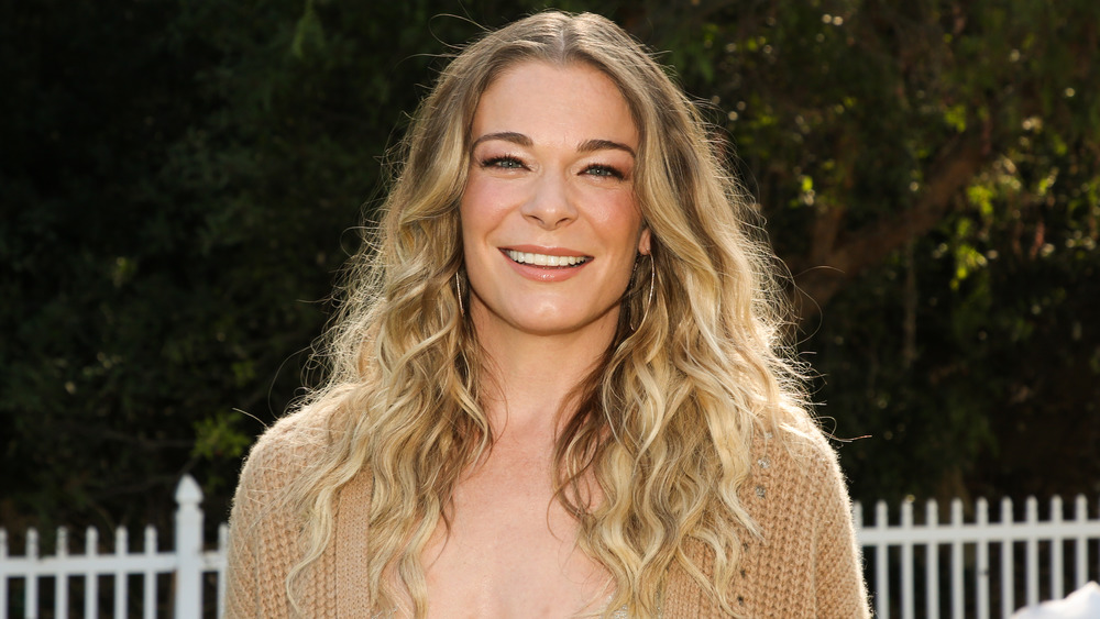 Leann Rimes smiling in beige sweater