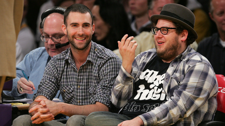Jonah Hill and Adam Levine laughing at a game