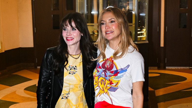 Kate Hudson and Zooey Deschanel smiling for the cameras together