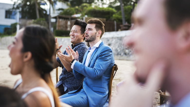 Wedding attendees clapping and cheering