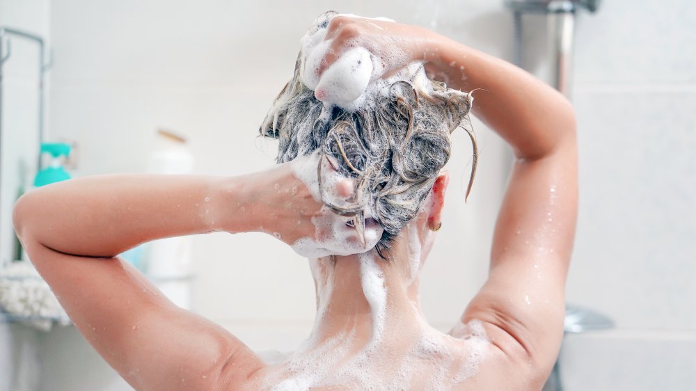 Woman shampooing hair