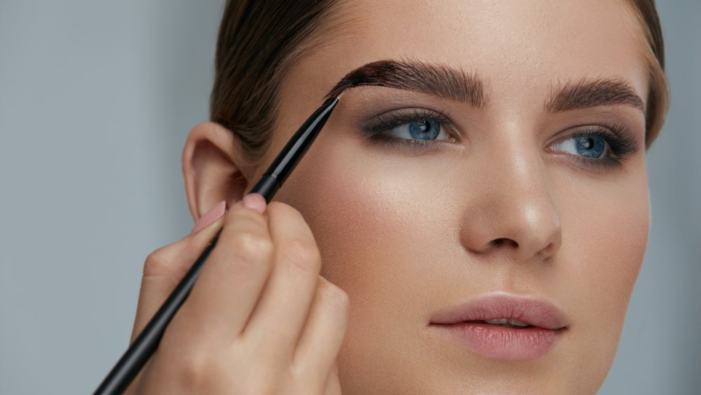 Woman applying makeup