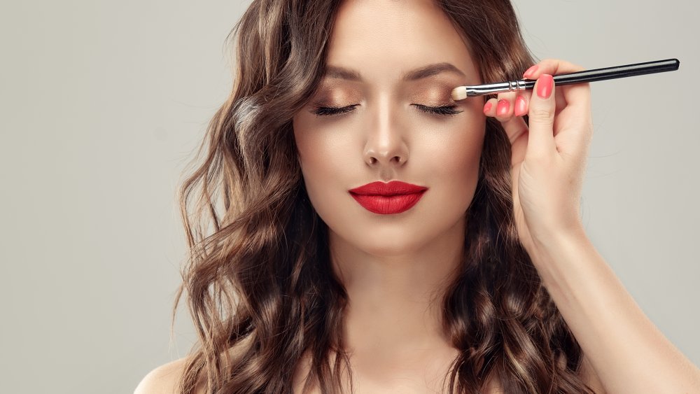 Woman applying makeup