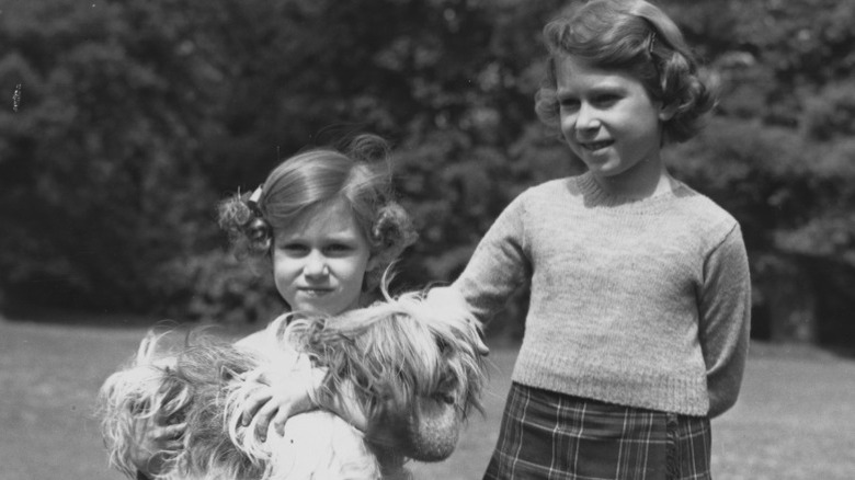 Princess Margaret and the future Queen Elizabeth II at the Royal Lodge with Chu-Chu the dog (1936)