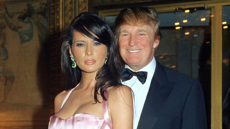Donald Trump poses with a brunette Melania Trump in the 2000s