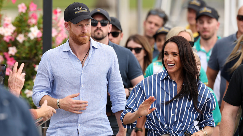 Meghan Markle and Prince Harry walking while strolling together in Australia
