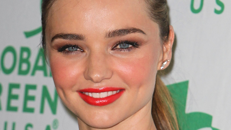 Miranda Kerr wearing red blush and tinted lip gloss