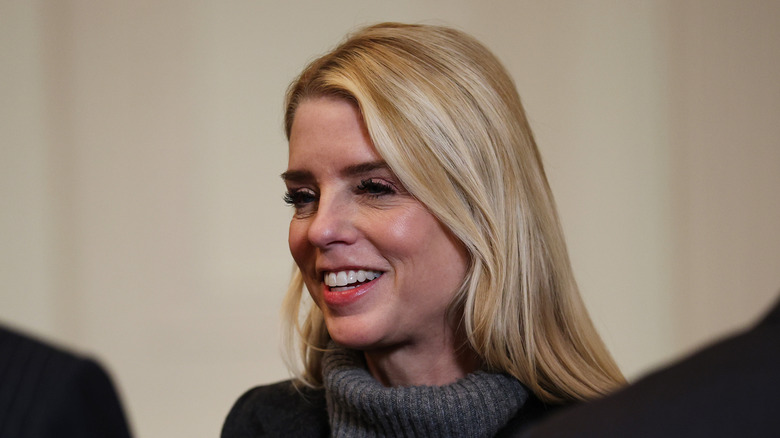 Pam Bondi smiling at the White House in March 2026