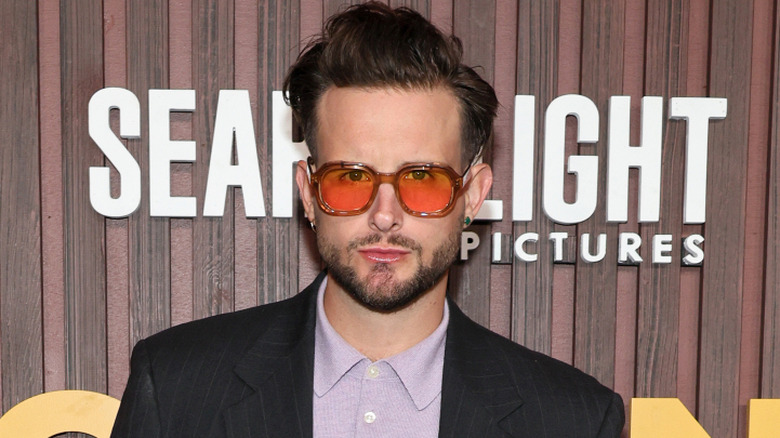 Nico Tortorella posing at the Kinds of Kindness premiere