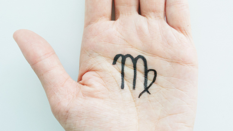 Woman with Virgo symbol on her hand