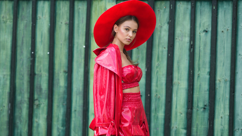 Woman in a red hat and red leather outfit