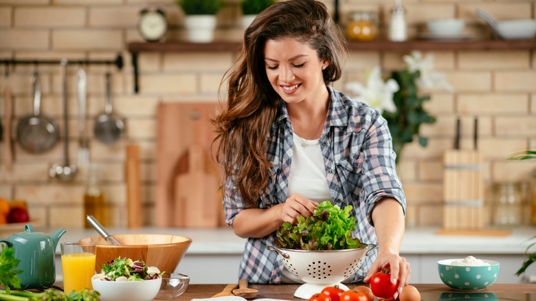 Woman cooking with fruits and vegetables