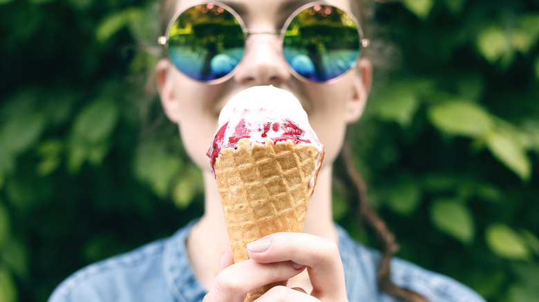 Woman eating an ice cream and smiling