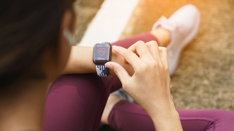 Woman looking at fitness watch