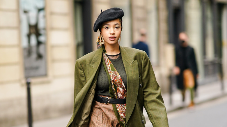 Model wearing beret in city