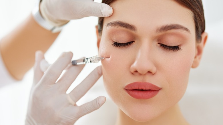 Woman receives facial injection