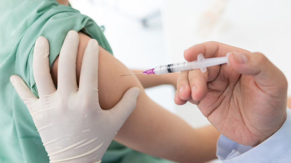 Kid getting vaccine shot in arm