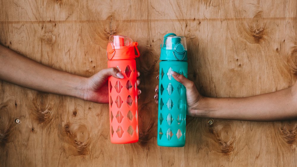 Women holding reusable water bottles