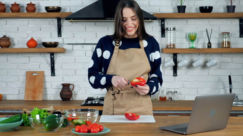 Woman hulling bell pepper