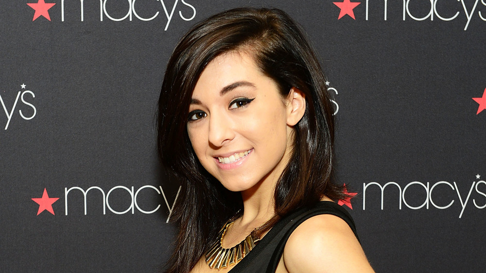 Christina Grimmie on a red carpet, smiling