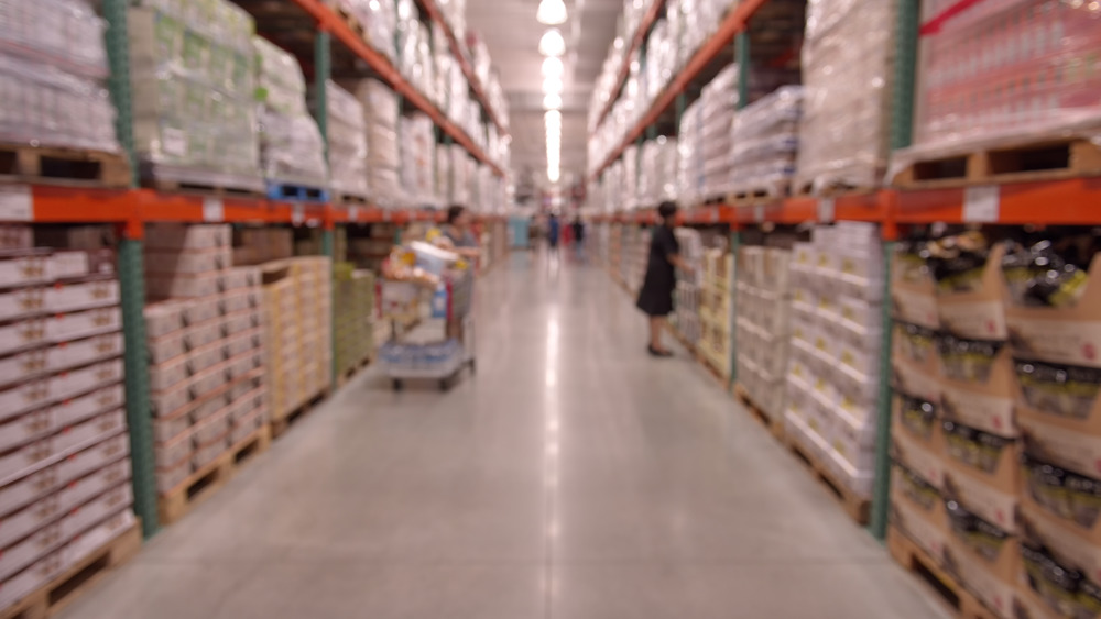 A woman amongst the towering Costco shelves