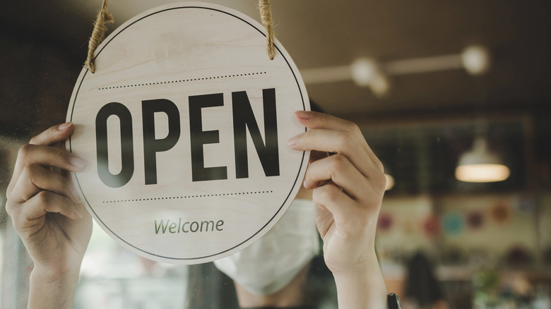 Store open and welcome sign