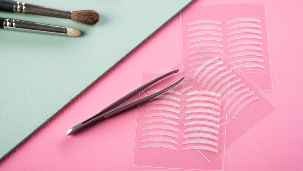 Eyelid tape pictured with tweezers 