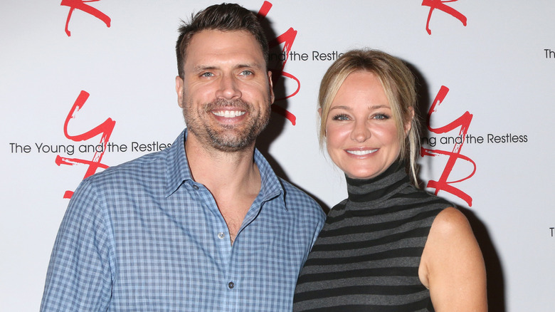 Joshua Morrow and Sharon Case smiling