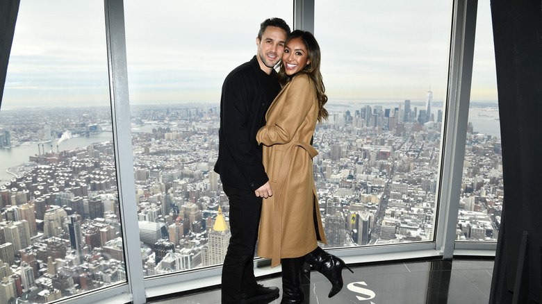 Zac Clark posing with Tayshia Adams