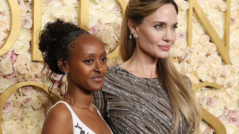 Zahara Jolie-Pitt poses next to Angelina Jolie while wearing her hair in a curly updo