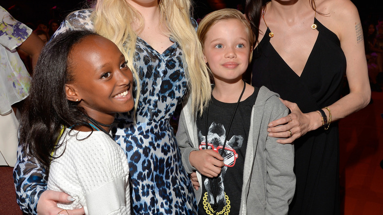 Zahara Jolie-Pitt smiles next to her sister, Shiloh Jolie-Pitt